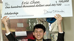 Eric Chen holds a check for the $100,000 he won in scholarship money in the national Siemens Competition in Math, Science & Technology. Image: Siemens Foundation