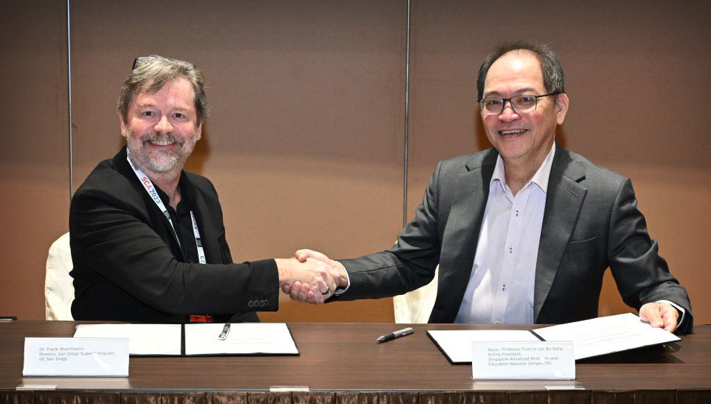 SDSC Director Frank Würthwein (left) and SingAREN’s Acting President Francis Lee Bu Sung shake hands during the signing of the MOU in Singapore. 