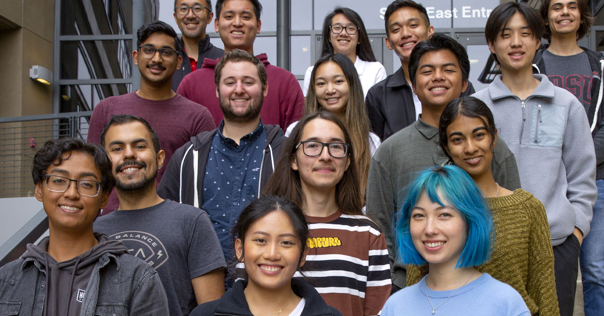 A group of undergraduate interns and mentors on the front steps of SDSC. 