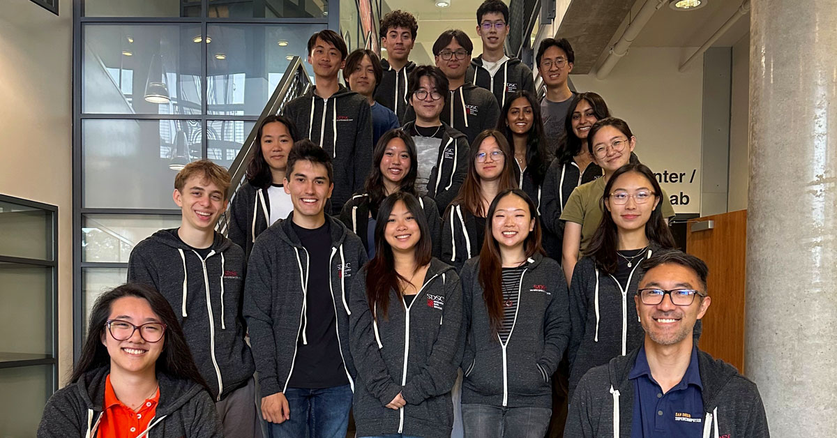 SDSC interns and staff pose for a group photo on a staircase.