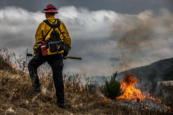 Marine Corps firefighter Sgt. Jake McClung supervises a controlled burn at Marine Corps Base Camp Pendleton, California. 