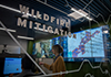 woman monitors computer display showing wildfire data