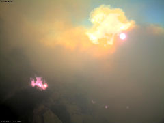 HPWREN also connects fire camps, fire stations, and provided data communications support to six Incident Command Posts about large wildfires. Cameras and other sensors provide further support, like in this photo from the 2007 California wildfires, showing the flames on the mountain underneath the camera.