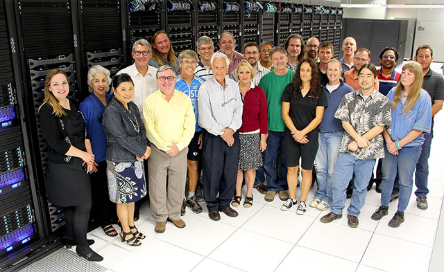 SDSC’s Comet Launch Team. SDSC Director Mike Norman (yellow shirt) is Comet’s PI; SDSC Deputy Director Richard Moore (behind Mike) is co-PI of the petascale supercomputer project. Photos by Ben Tolo/SDSC