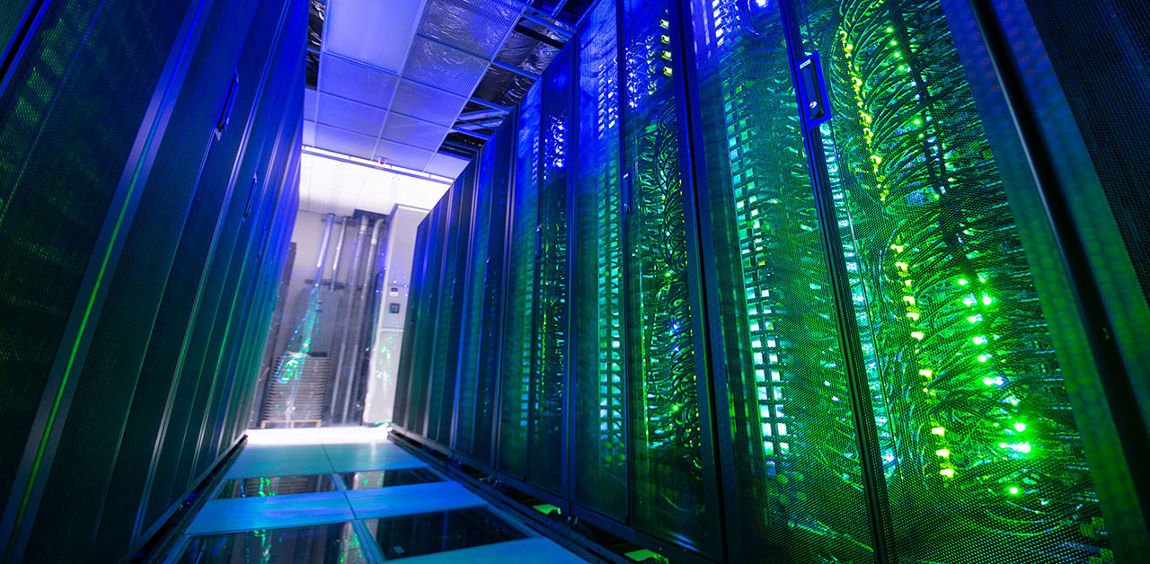 Twinkling lights inside the server racks of the Expanse supercomputer. 